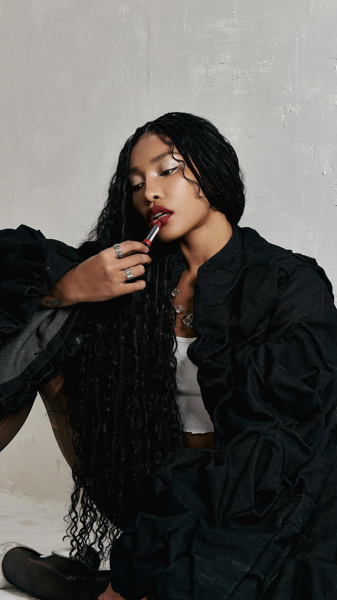 enigma model applying lipstick dramatically
