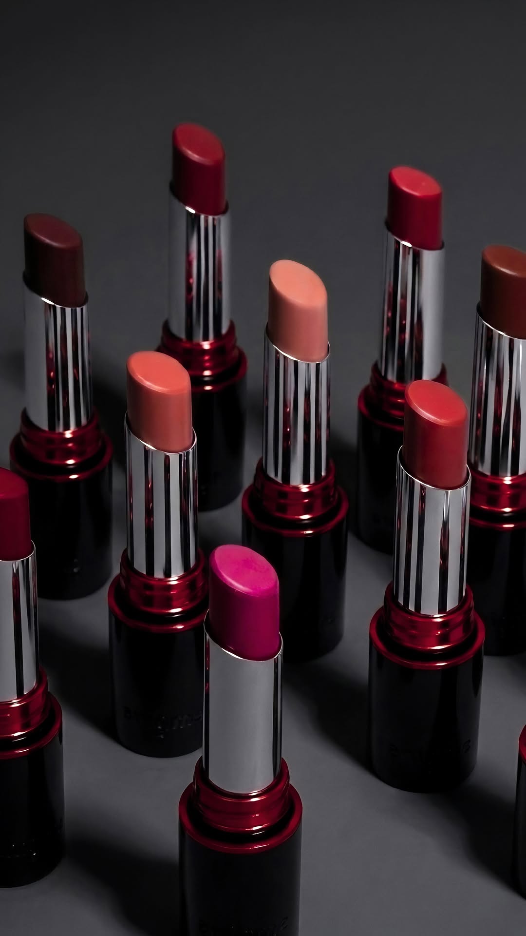 12 LIPLORE lipstick bullets arranged on dark surface