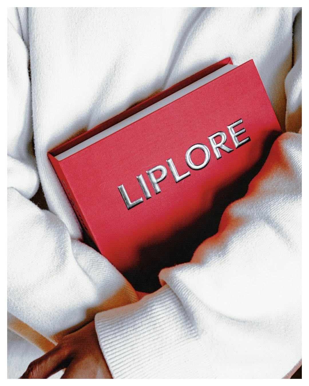 Red LIPLORE box held in hands